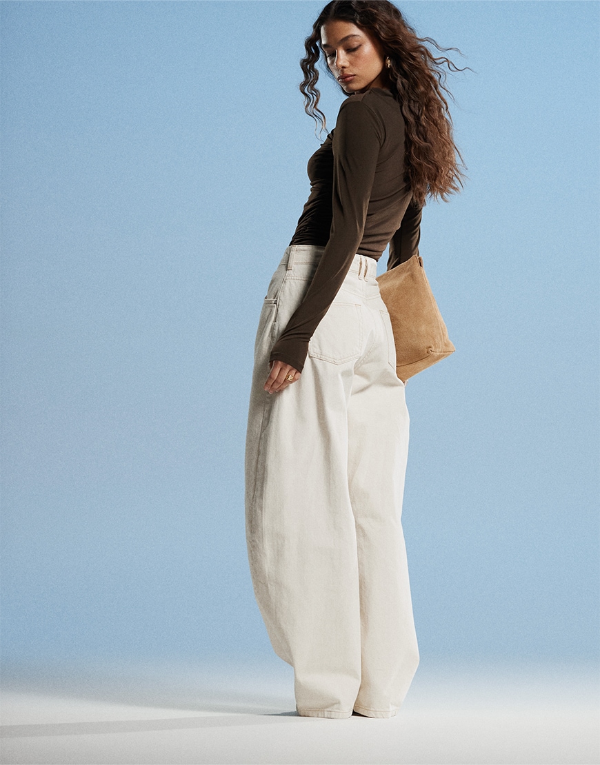 Model wearing white jeans and black top