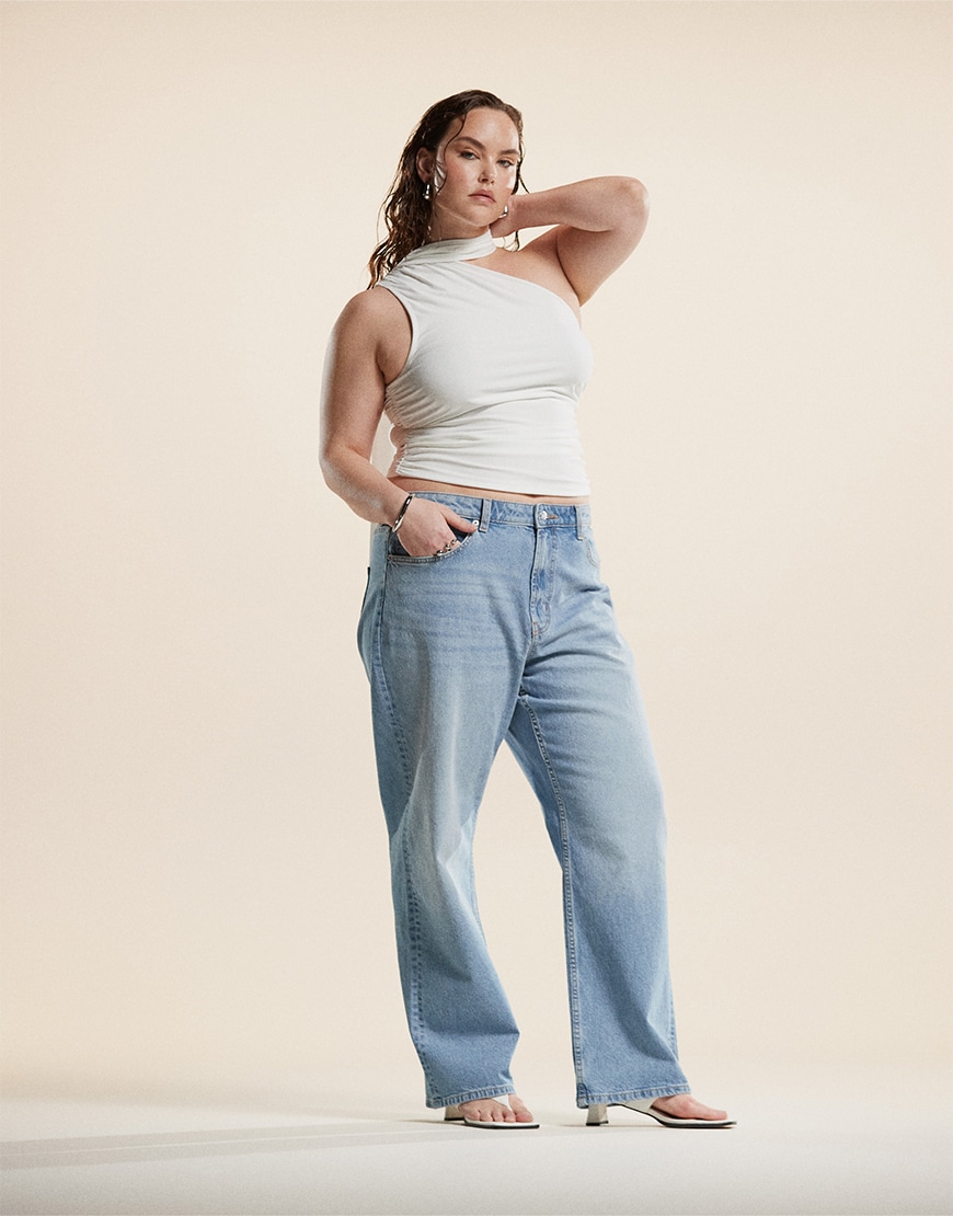 Model wearing white top and light blue jeans