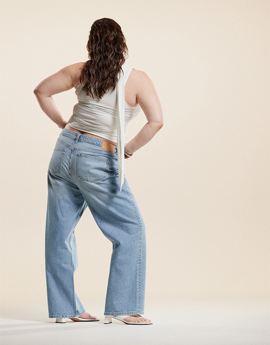 Model wearing white top and light blue jeans