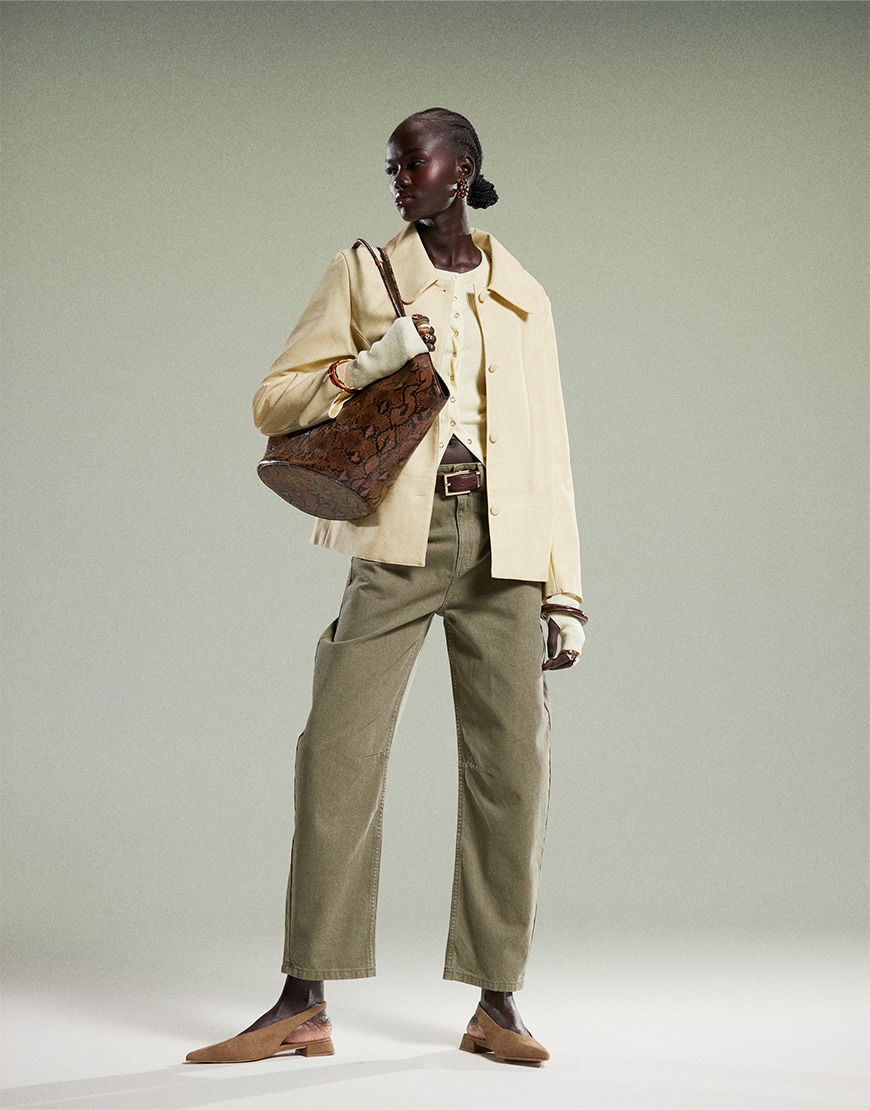 Model wearing yellow top and jacket, and green jeans | ASOS Style Feed