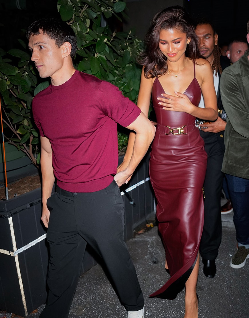 Zendaya and Tom Holland wearing wine red outfits
