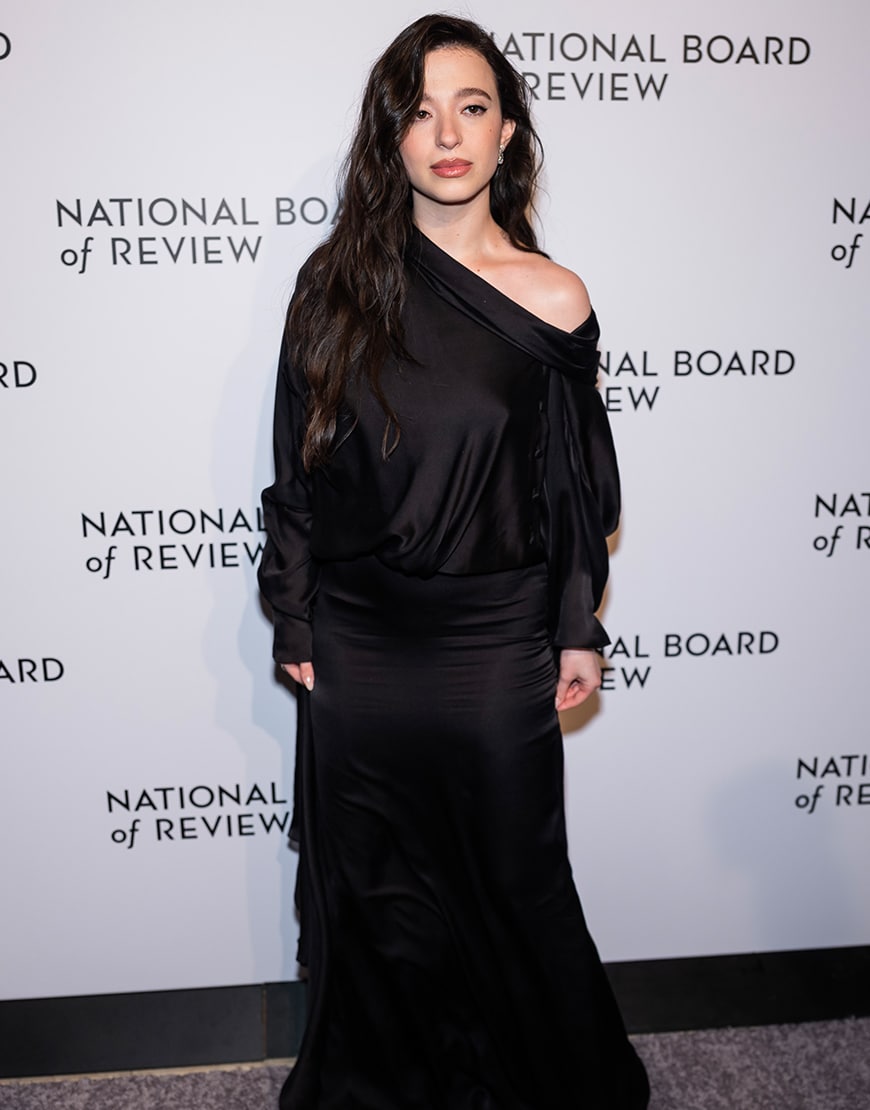 Mikey Madison wearing a black off shoulder maxi dress