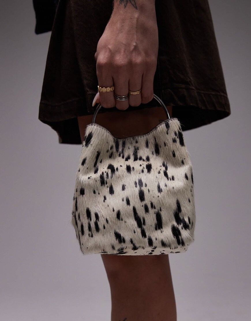 A model holding a dalmatian print bag | ASOS Style Feed