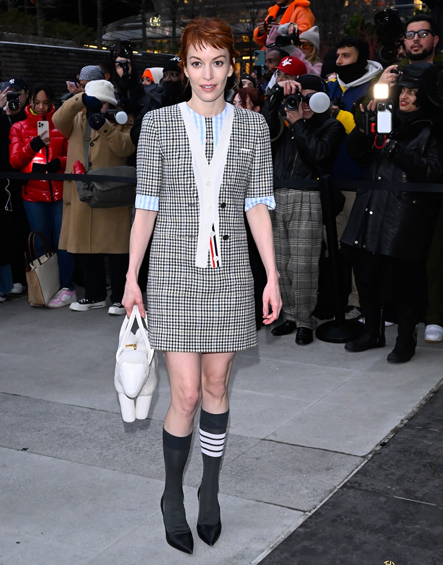 Britt Lower wearing a checkered Thom Browne dress
