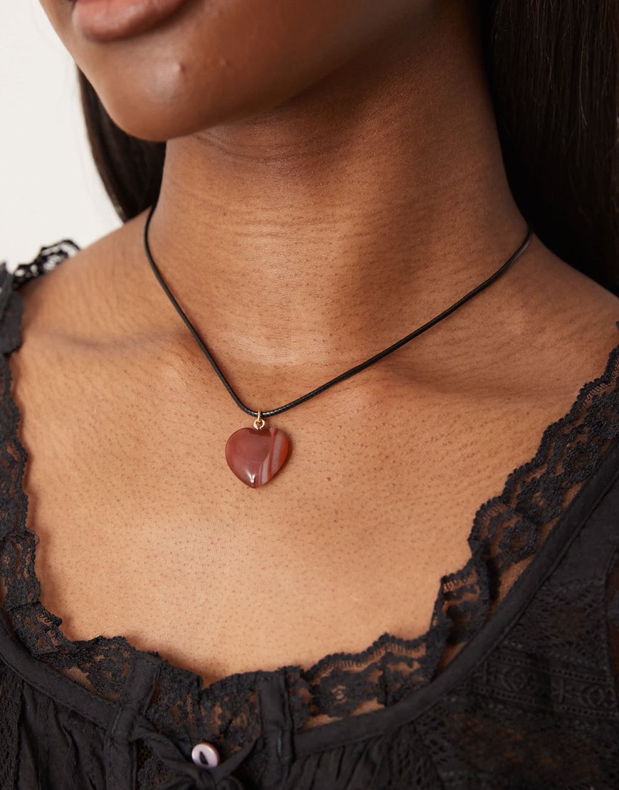 Red heart pendant on black cord necklace