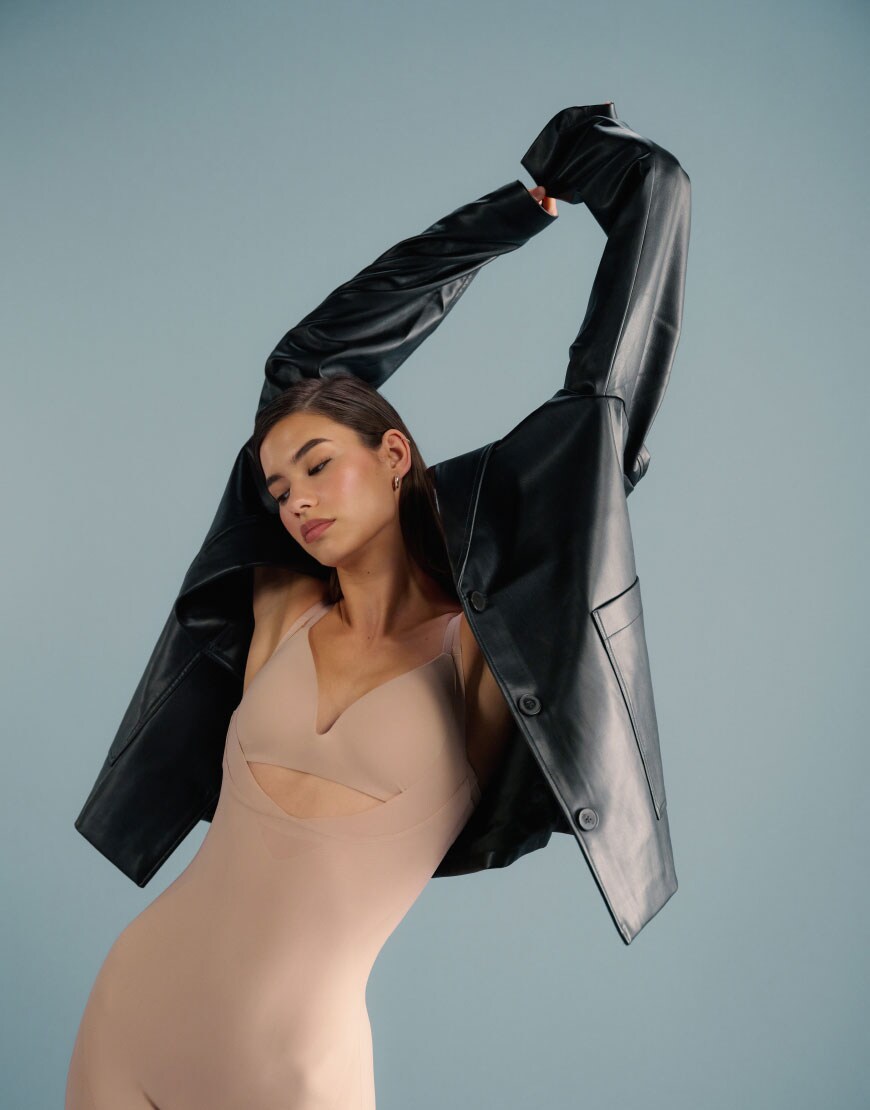 A model wearing Calvin Klein shapewear with a leather blazer | ASOS Style Feed