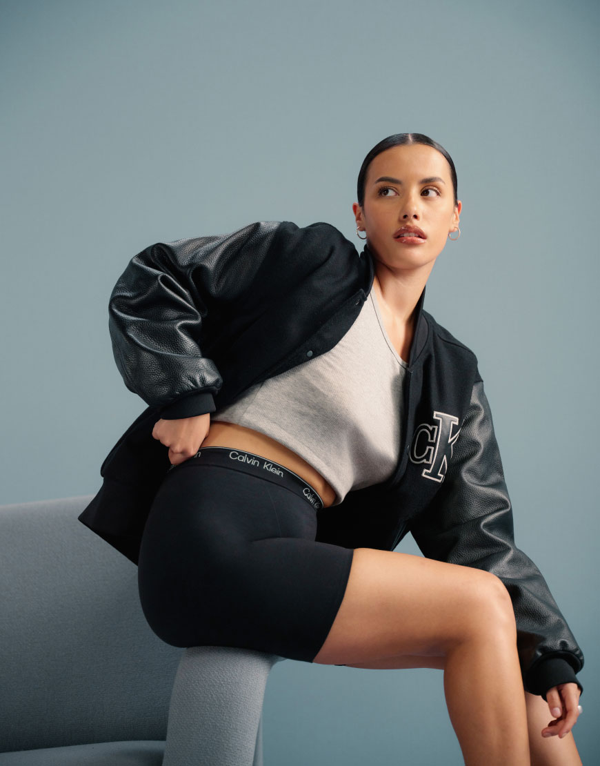 A model wearing Calvin Klein shapewear with a varsity jacket | ASOS Style Feed