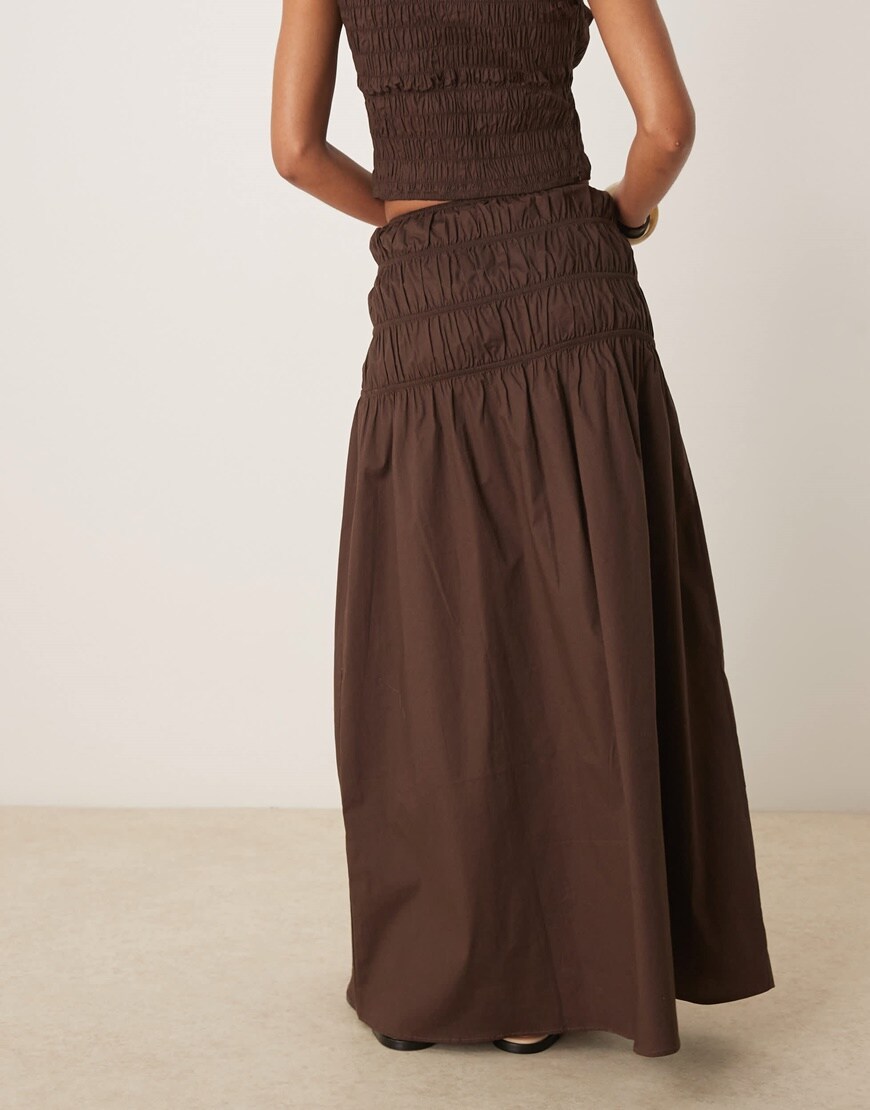 Model wearing a brown shirred maxi skirt