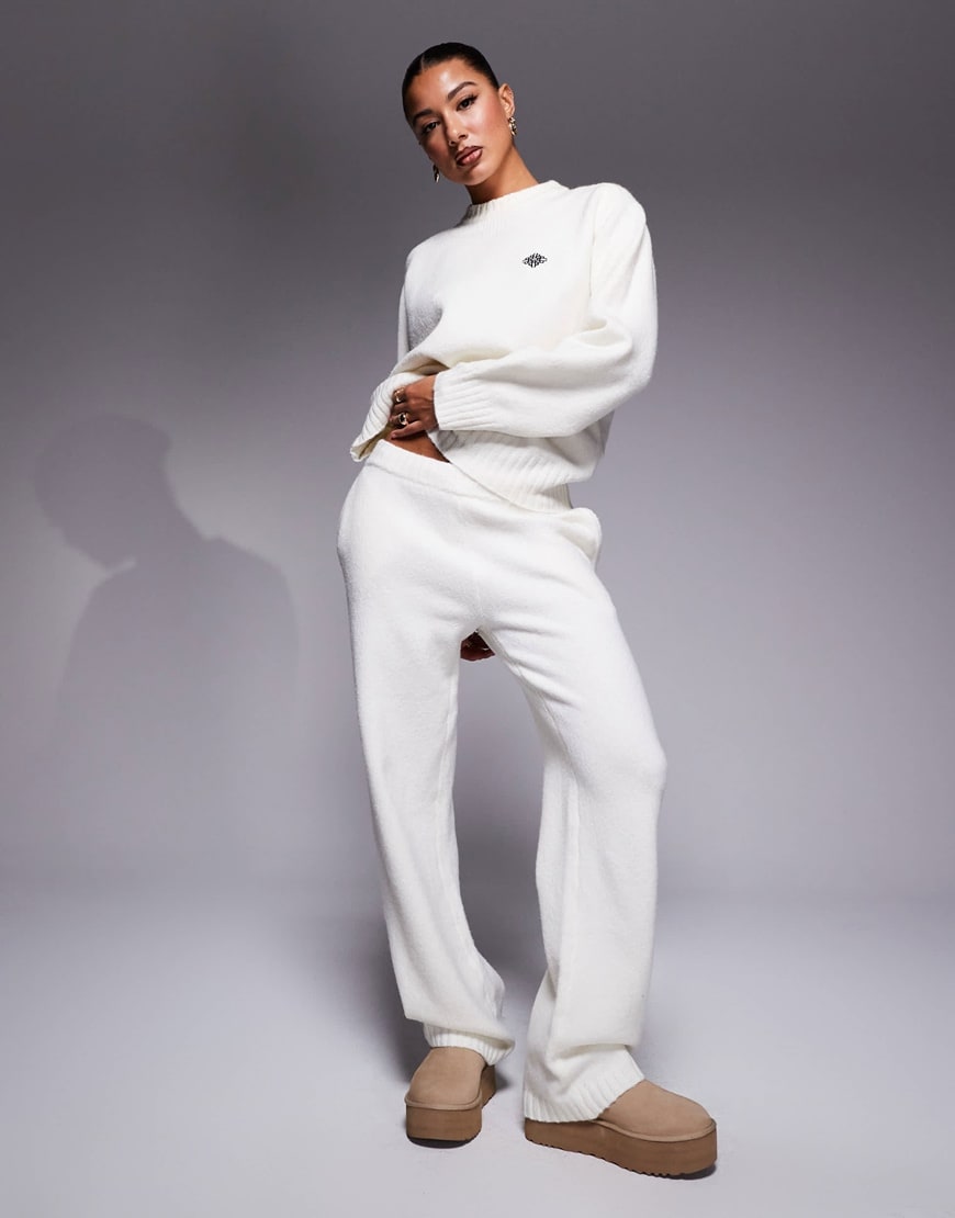 Model wearing a white tracksuit