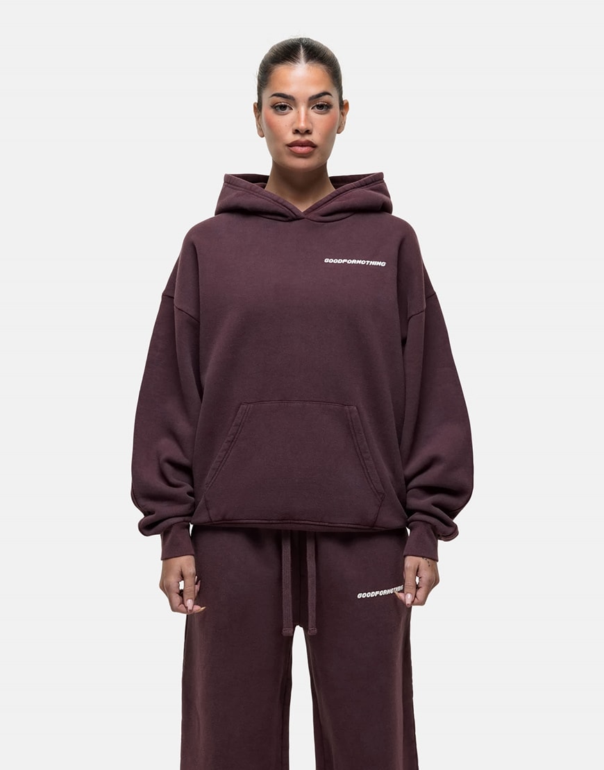 Model wearing a burgundy hoodie