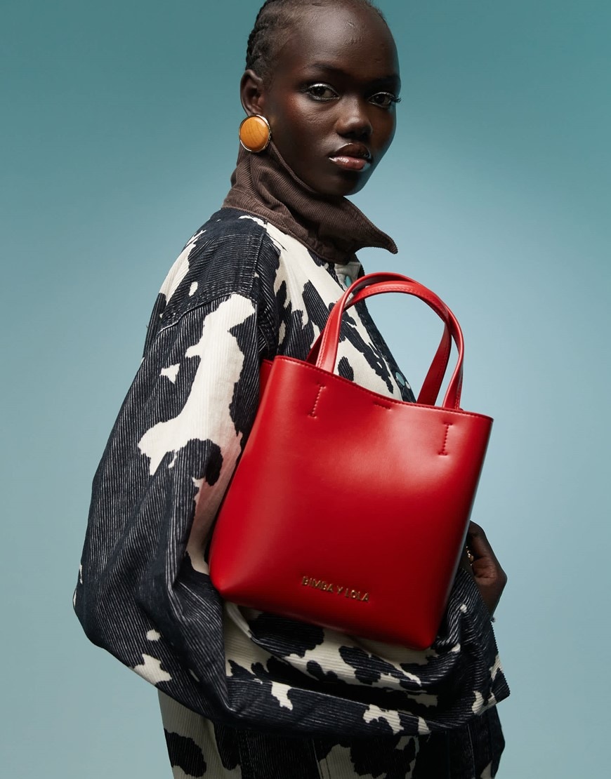 Model wearing fur coat holding a bag