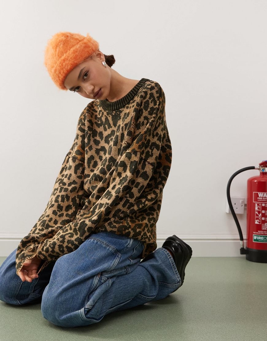 Model wearing a cheetah print knit jumper
