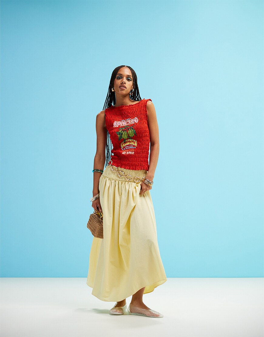 Woman wearing a red top and yellow skirt
