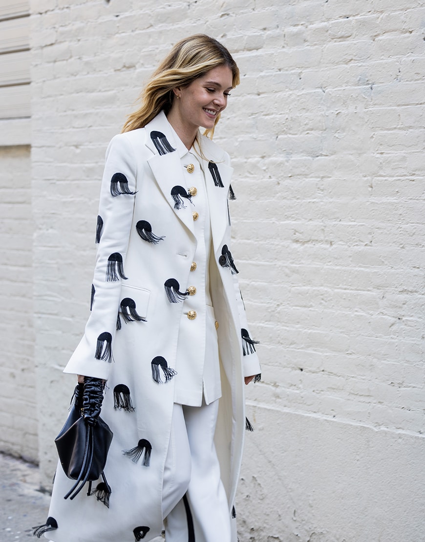 Meghann Fahy wearing a white suit jacket with black details