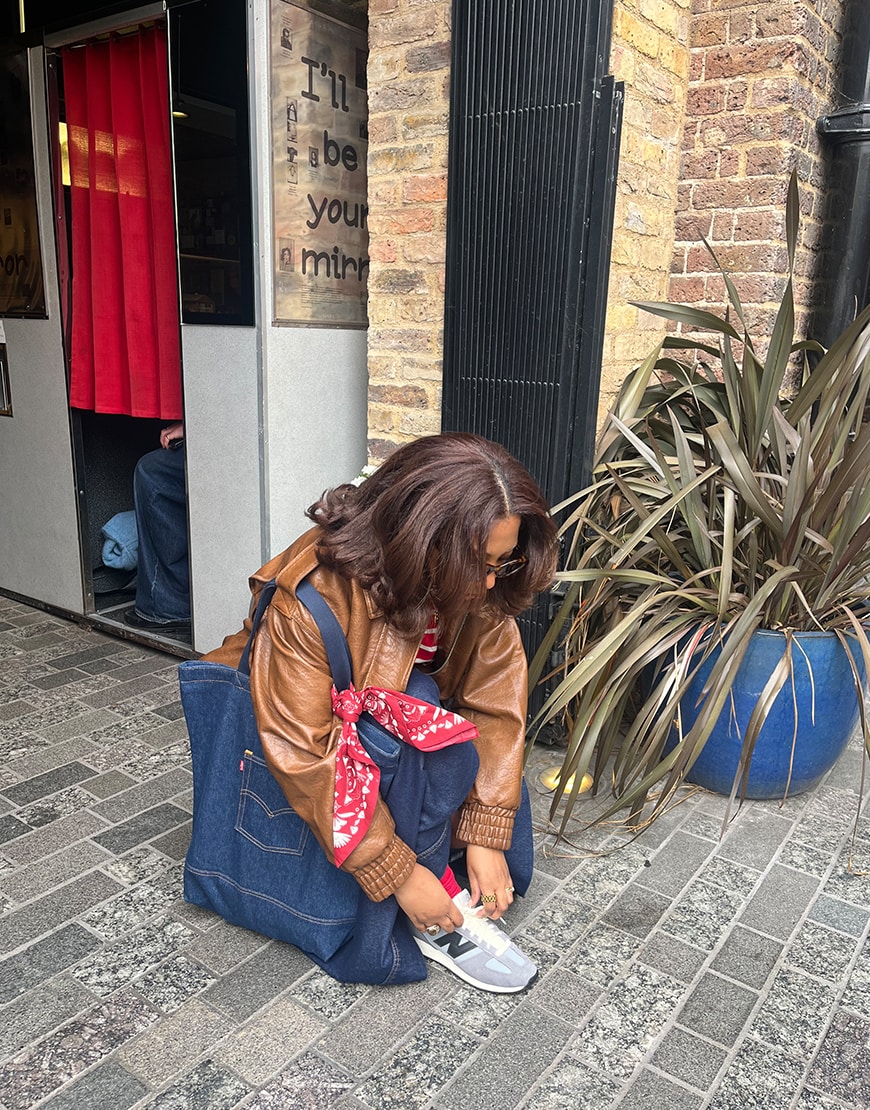 Barri-Allison wearing a denim jacket and New Balance 471 trainers