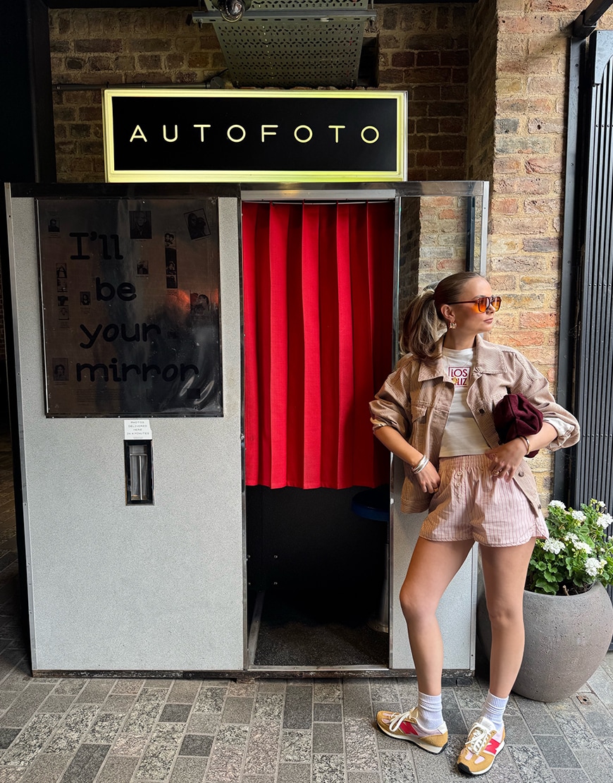 Bella wearing beige shorts and a beige jacket
