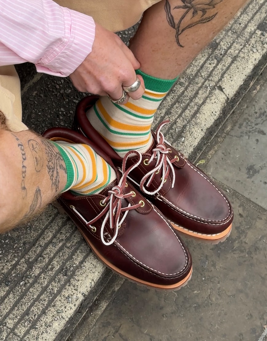 Man wearing Timberland boat shoes with striped socks
