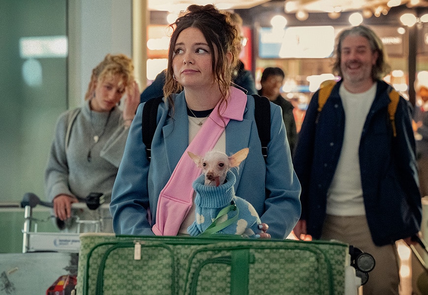Jessica (Megan Stalter) wearing blue blazer and Astrid (Mia) the dog wearing cloud patterned dog knit in Too Much Netflix series | ASOS Style Feed