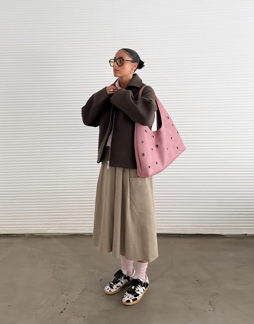 Woman wearing brown maxi skirt and jacket and adidas cow print Sambas | ASOS Style Feed