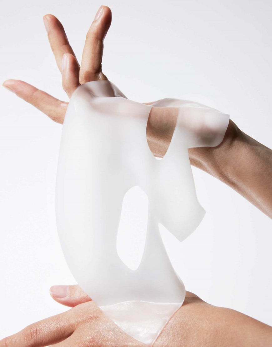 Hands holding a sheet mask