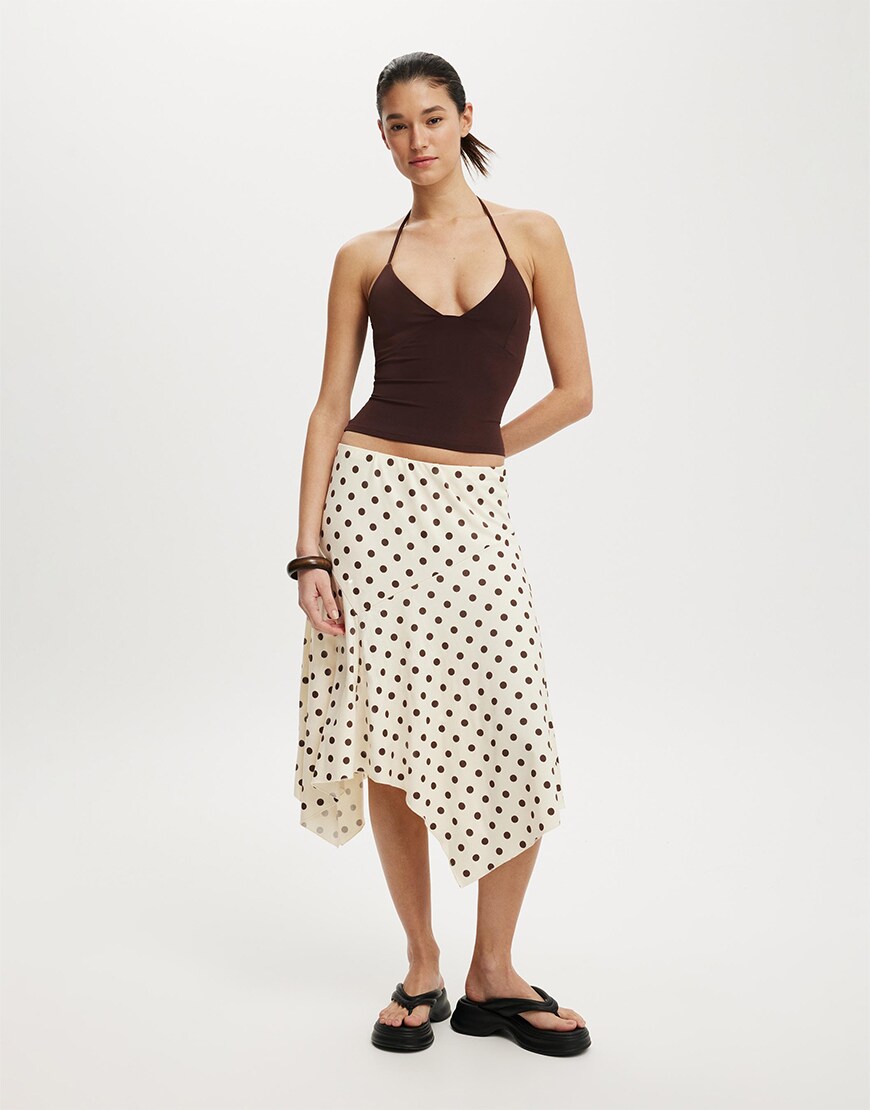 Woman wearing a cream polka dot skirt