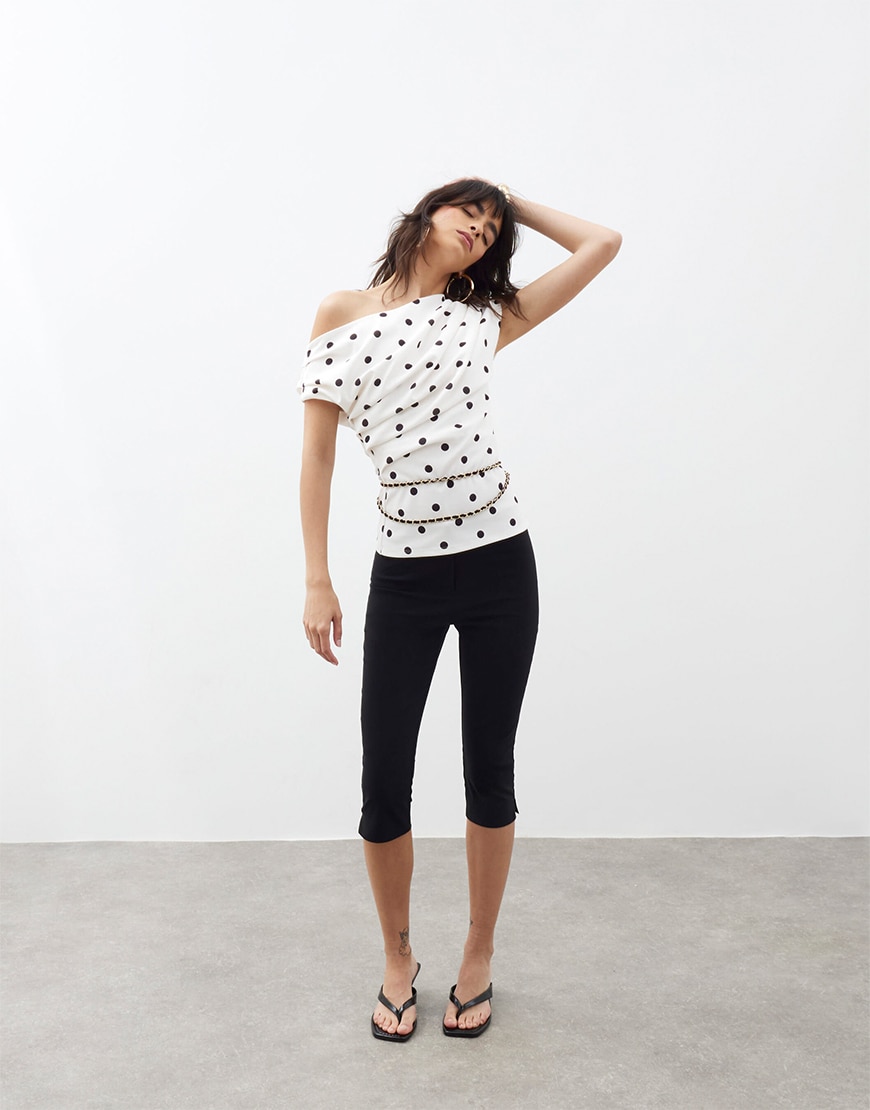 Woman wearing a white polka dot top