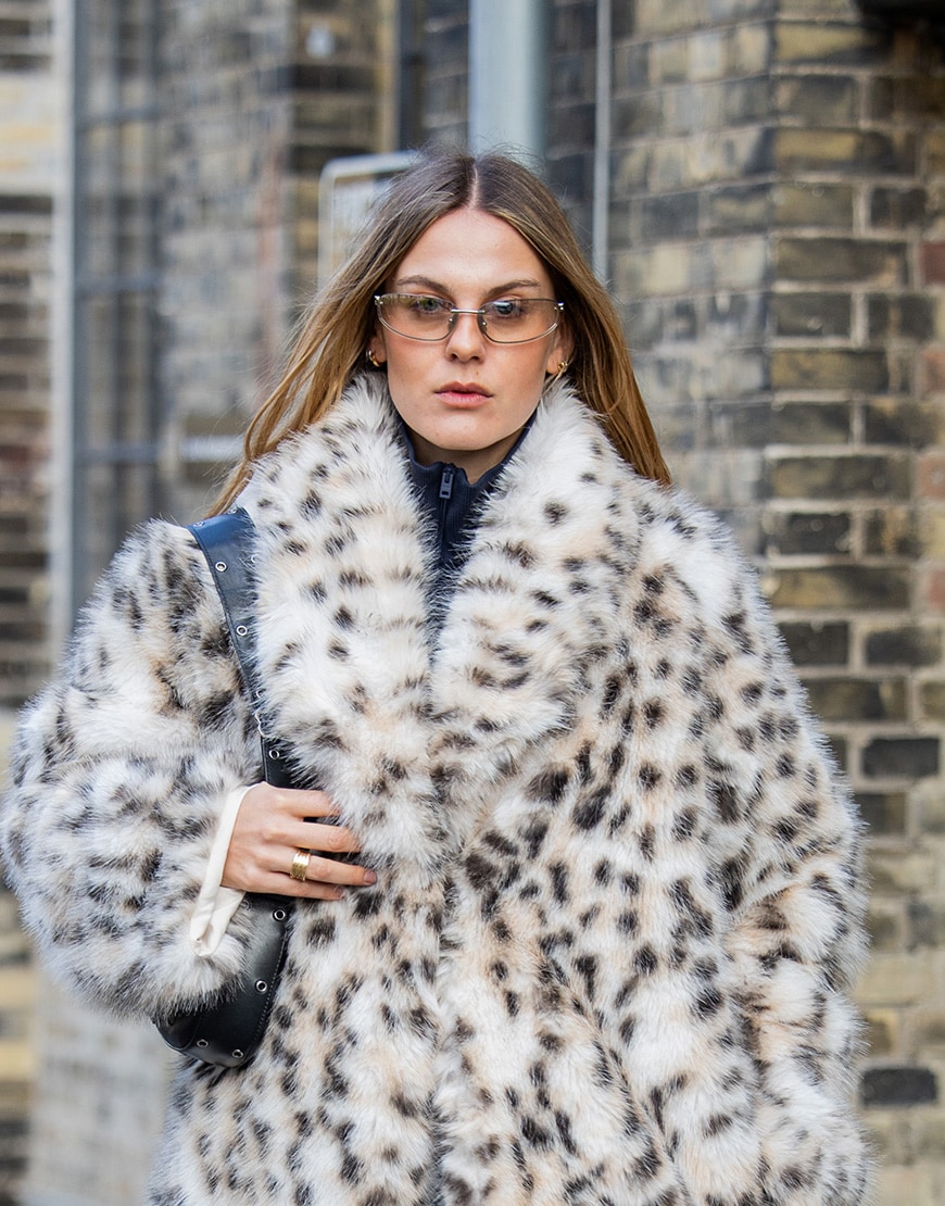 Woman wearing faux fur coat and silver sunglasses | ASOS Style Feed