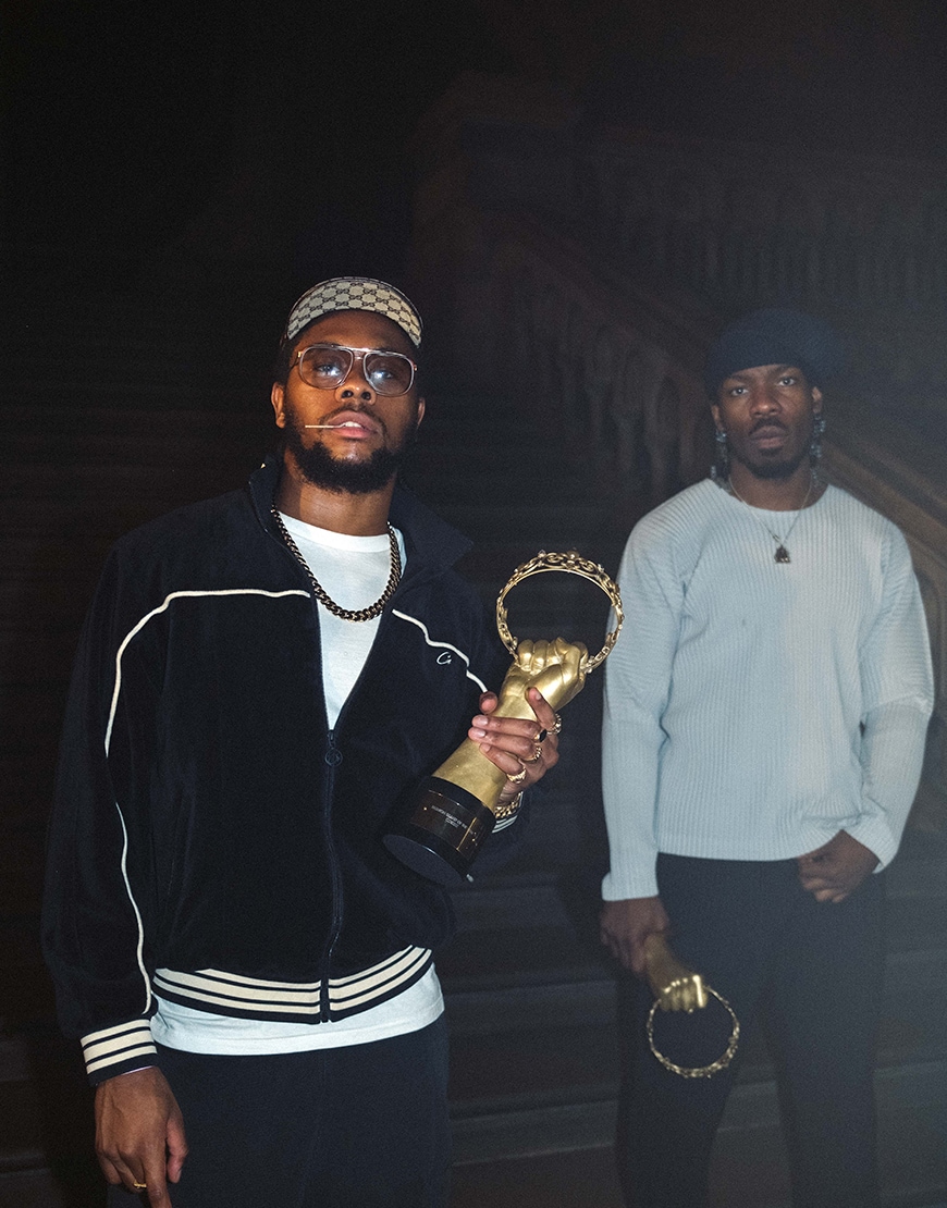 Two men holding a gold award