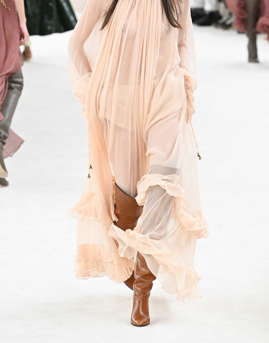 Woman wearing brown knee-high boots and pink dress | ASOS Style Feed