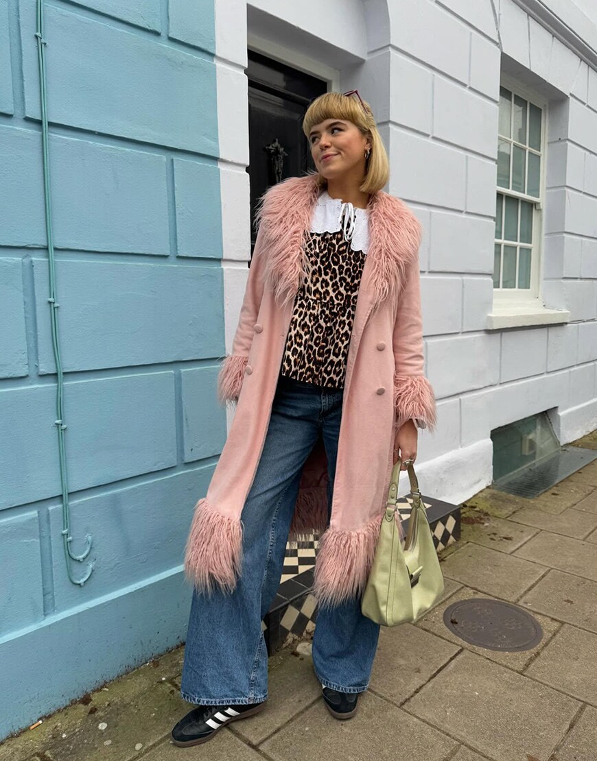 Woman wearing a pink Afghan coat