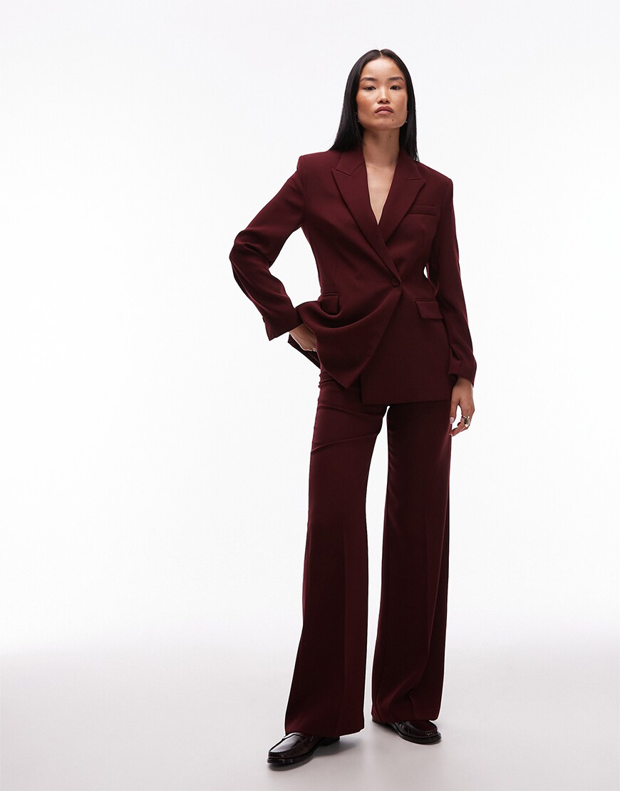 Model wearing a burgundy suit
