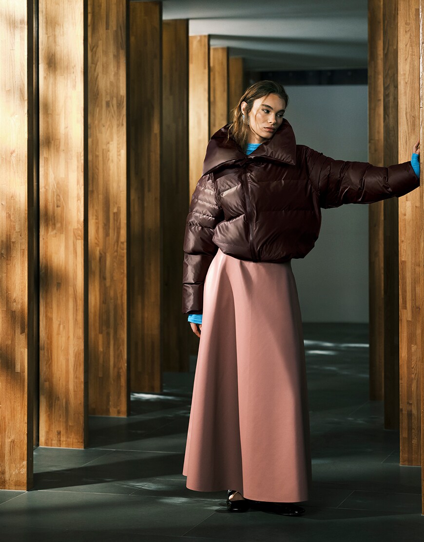 Model wearing a maxi skirt and puffer jacket