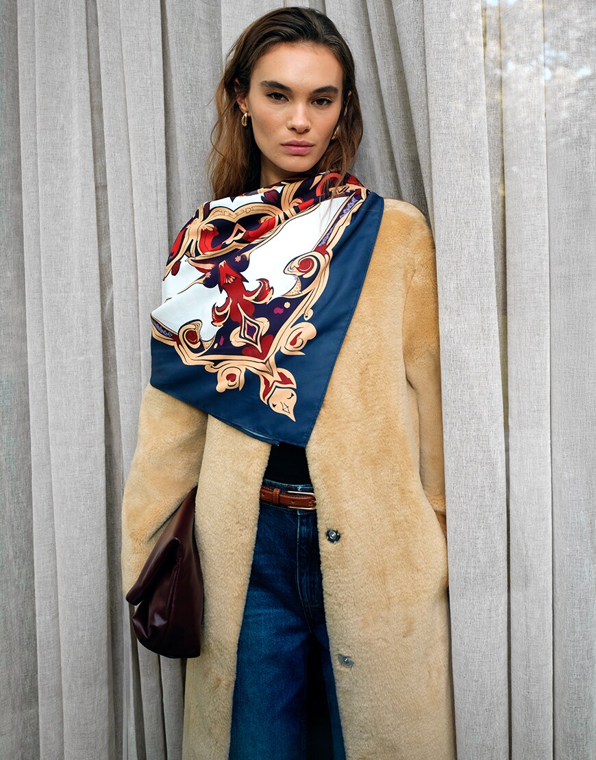 Woman wearing a satin scarf on her neck
