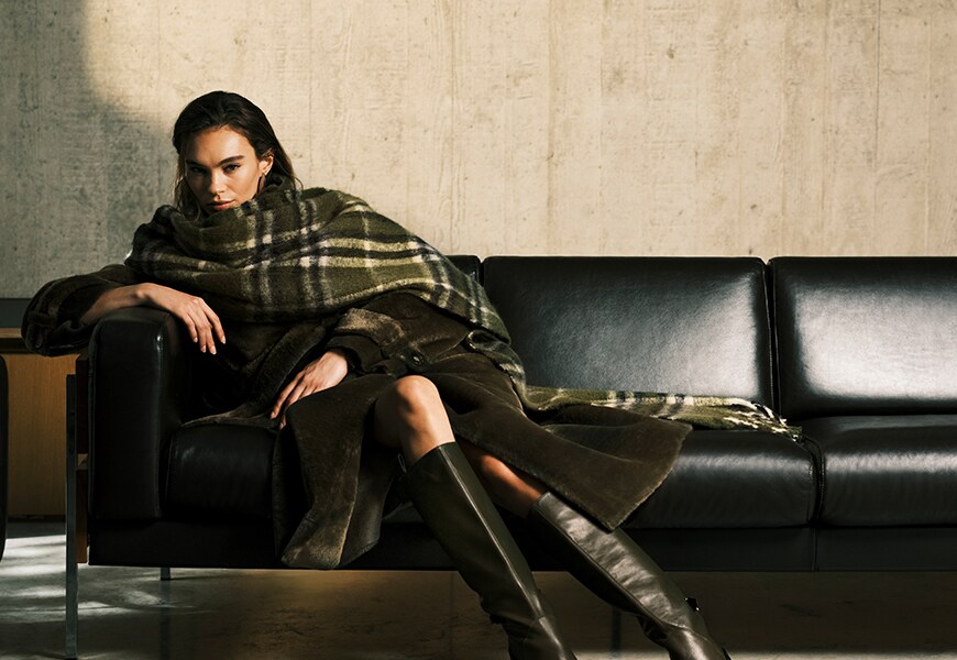 Woman wearing a green tartan scarf