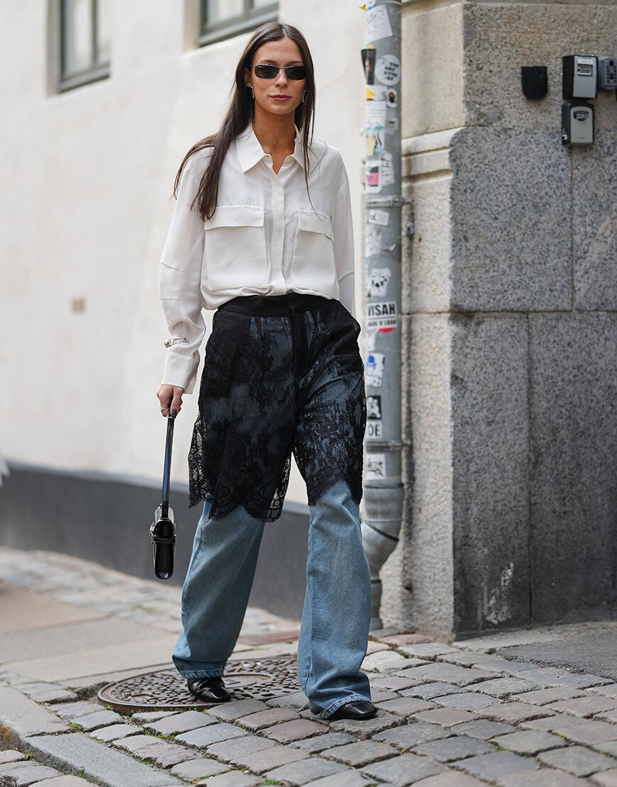 Woman wearing black lace skirt and jeans | ASOS Style Feed