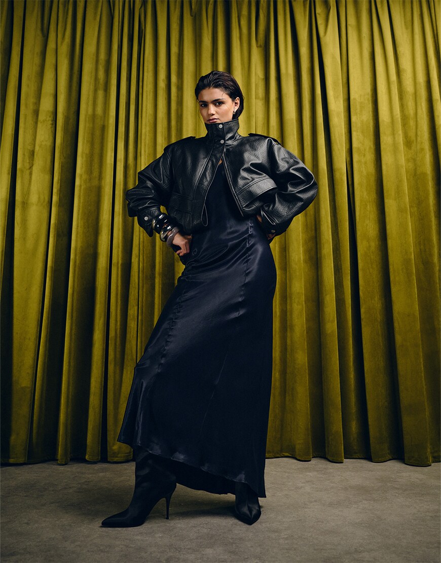 Model wearing a black satin dress