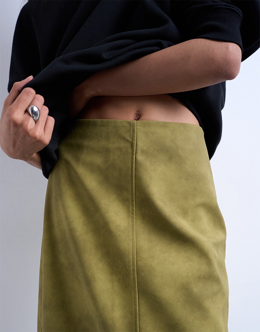 Woman wearing a green suede skirt