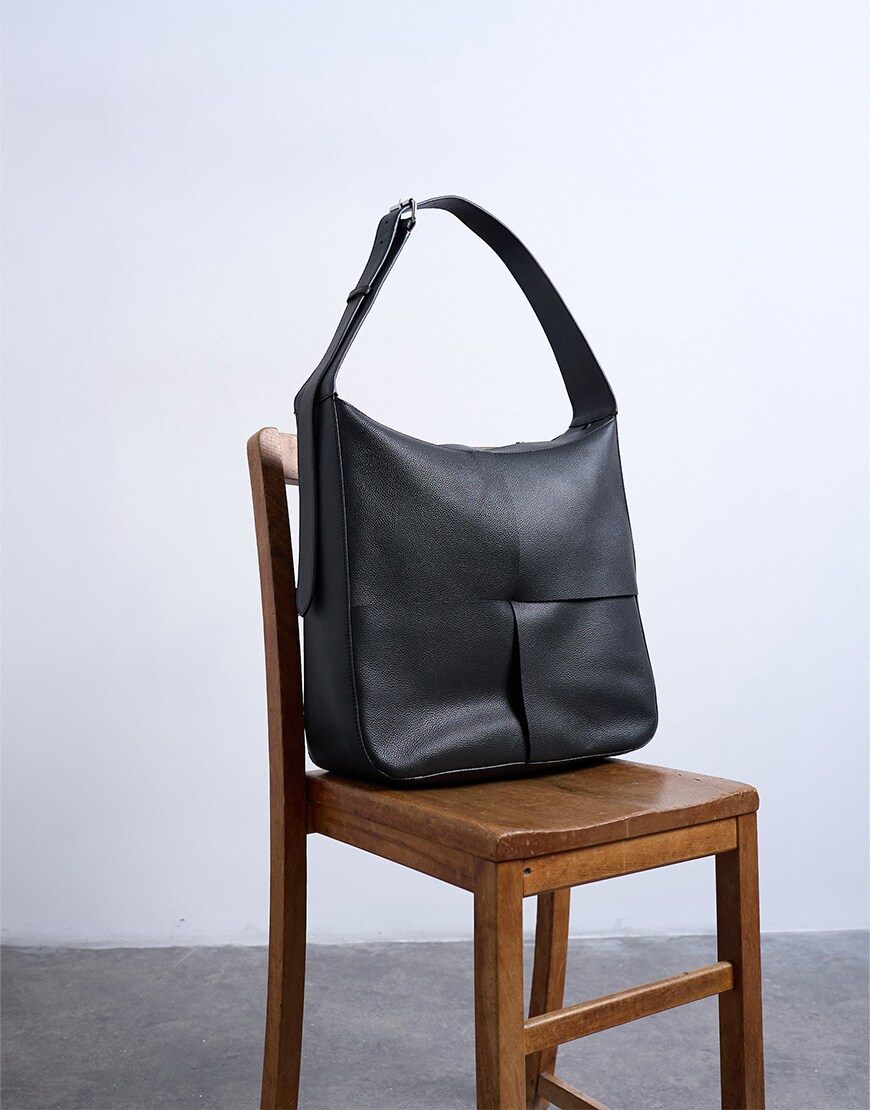 Black boxy tote bag on chair