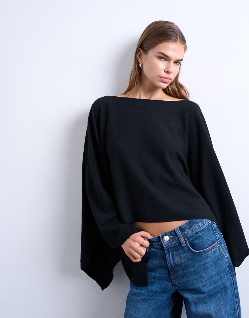 Woman wearing a black poncho