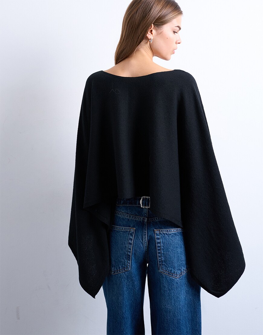 Woman wearing a black poncho