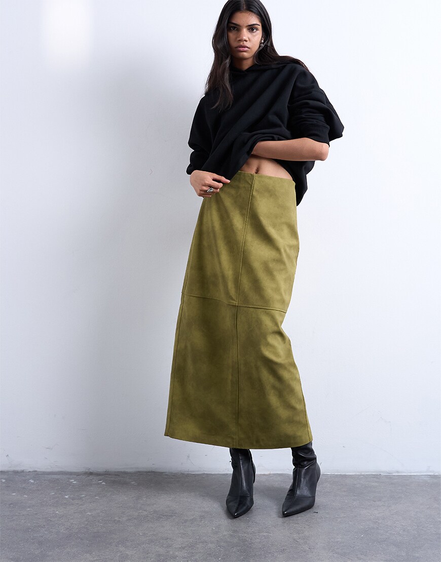 Woman wearing a green suede skirt