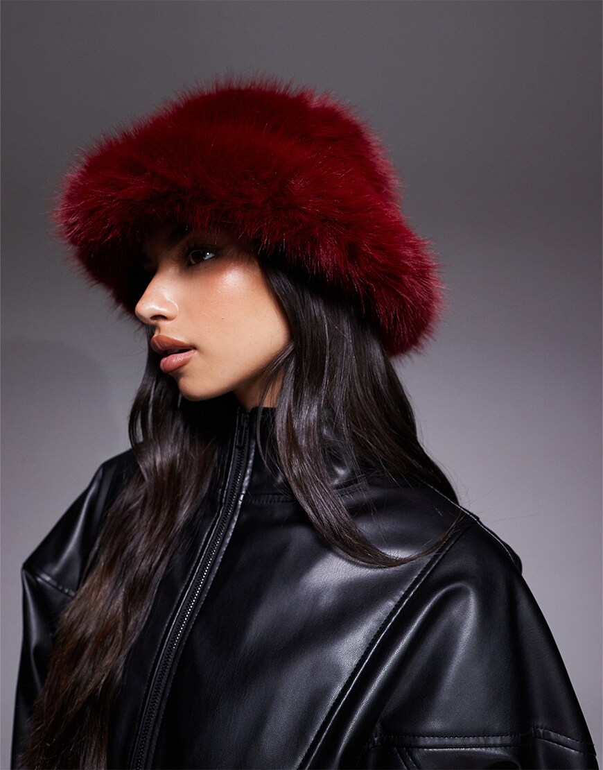 Woman wearing a red fur bucket hat