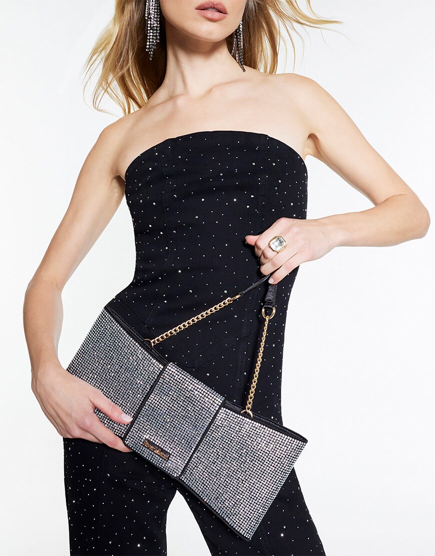 Woman holding a rhinestone black bag