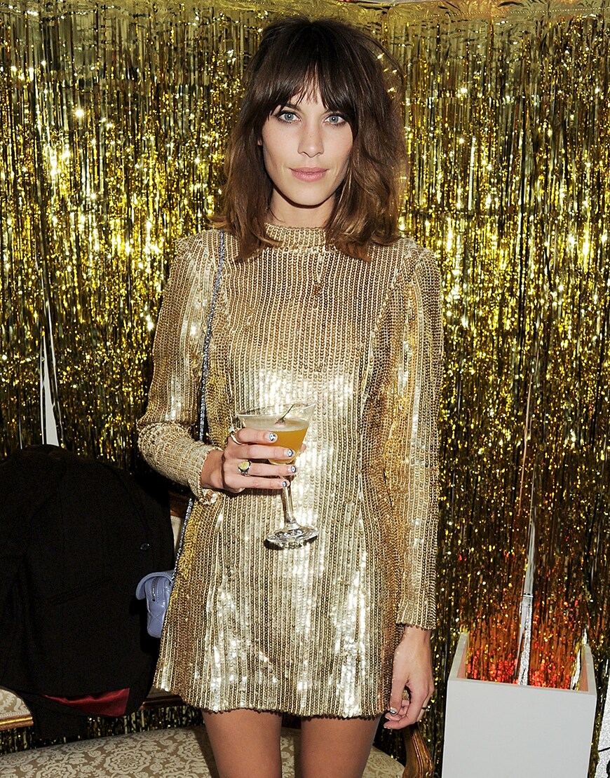 Alexa Chung wearing a gold dress