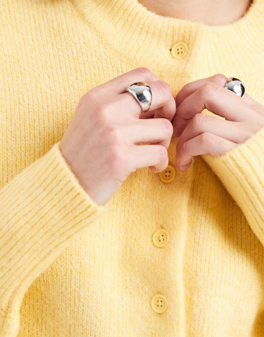 Yellow knit cardigan closeup