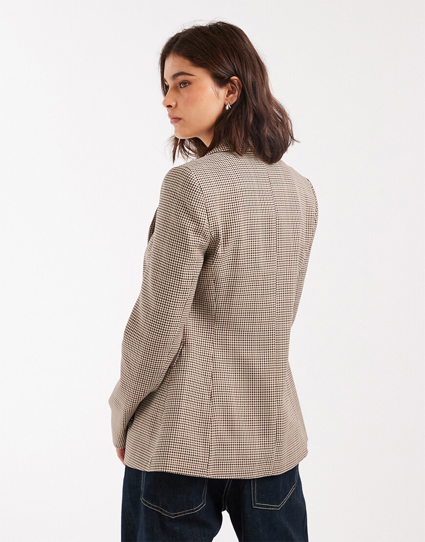 Woman wearing a check blazer