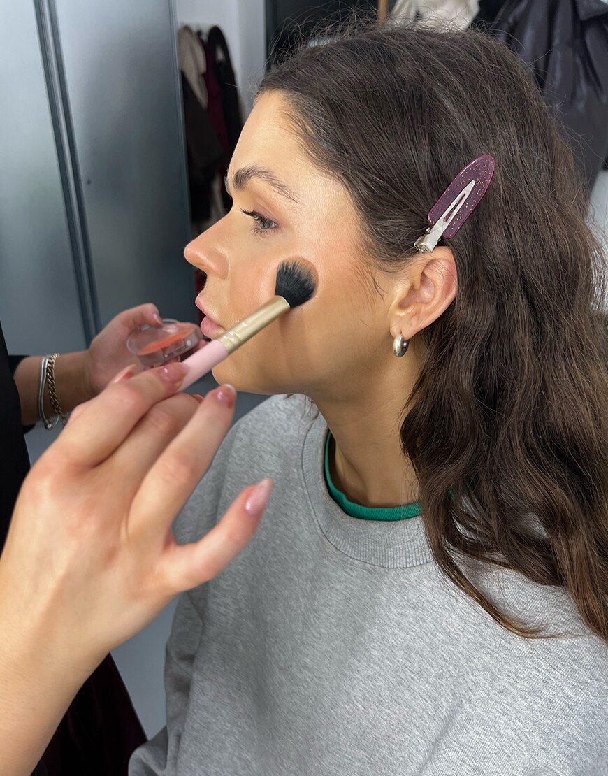 Model having her makeup done