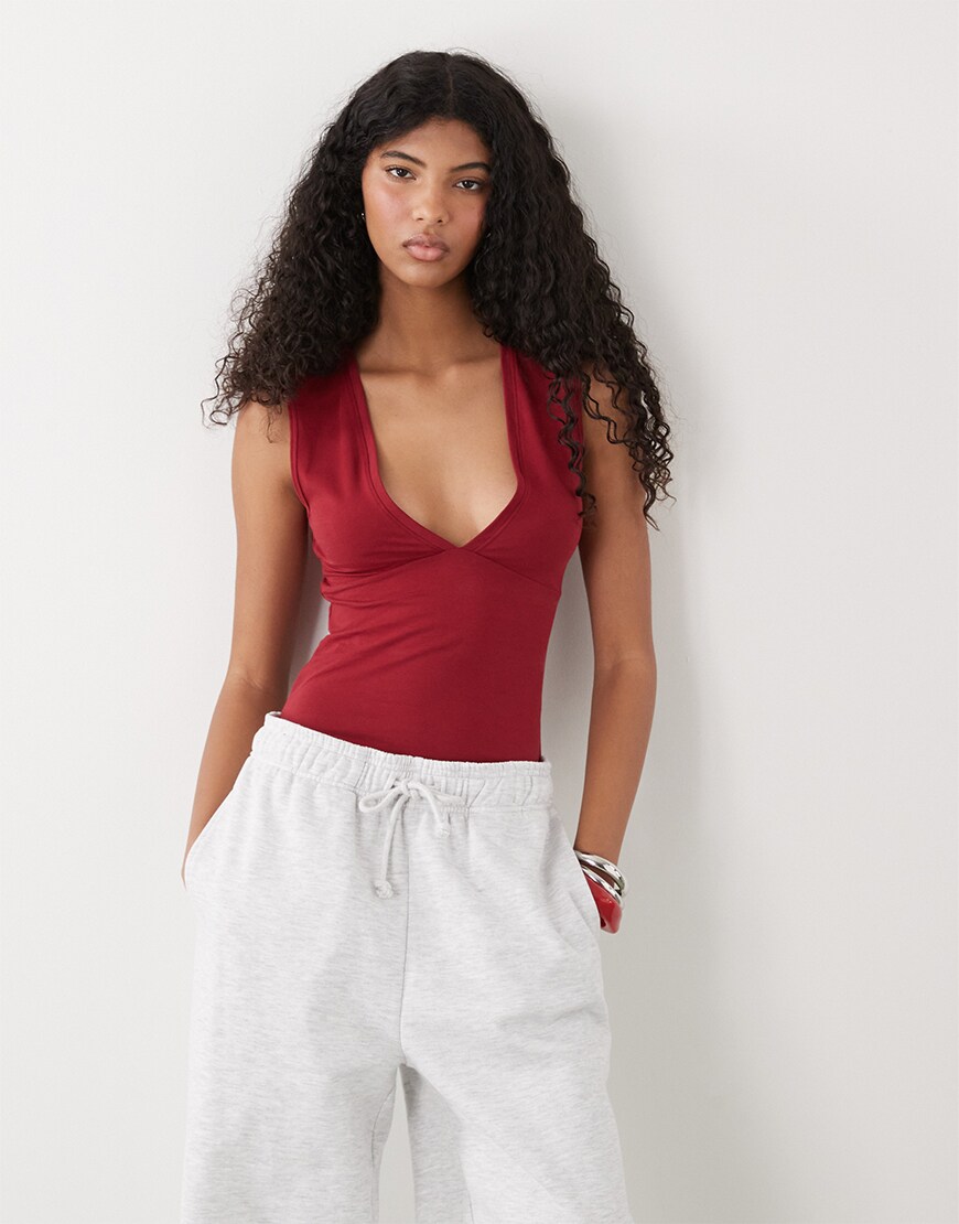 model wearing Weekday plunge v-neck top in cherry red|ASOS Style Feed