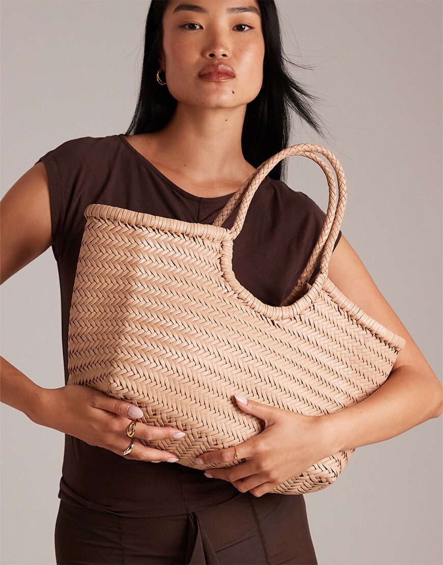 Woman holding a woven bag