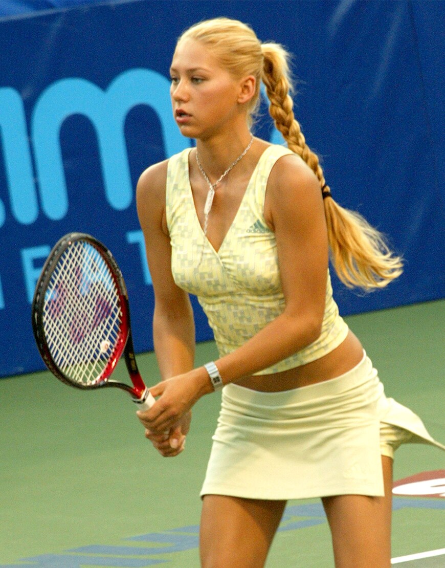 Anna Kournikova wearing a yellow outfit